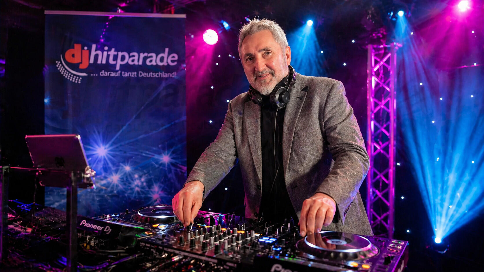 DJ im Nachtclub mit farbenfrohen Lichtern